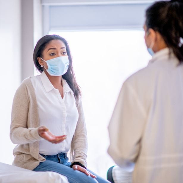 female in a provider's office talking about genetic testing