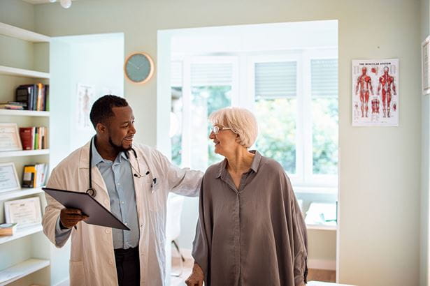 Doctor and senior patient talking about geriatric surgery