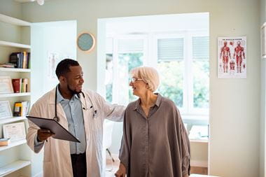 Doctor and senior patient talking about geriatric surgery